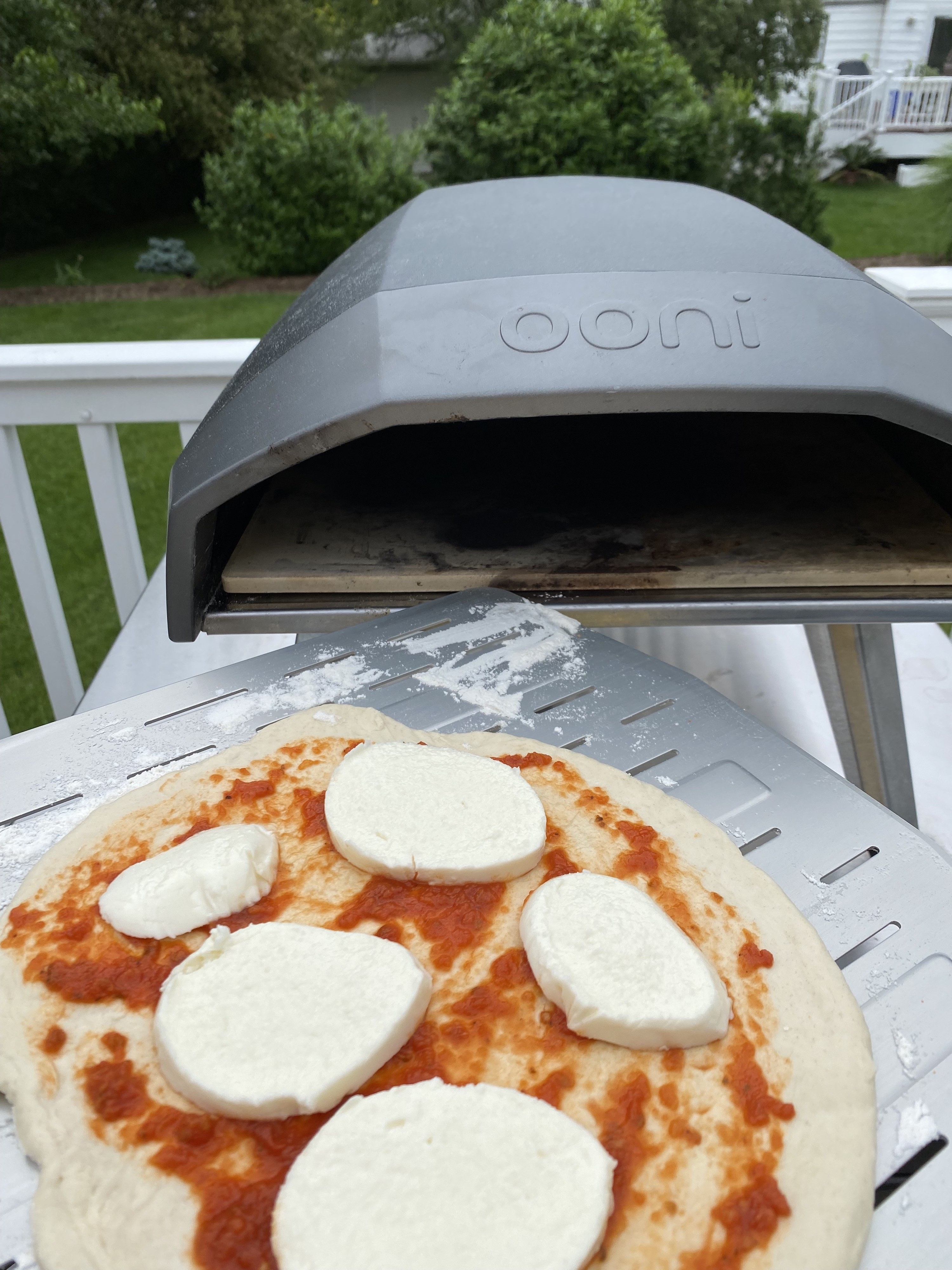 the pizza going into the oven to cook 