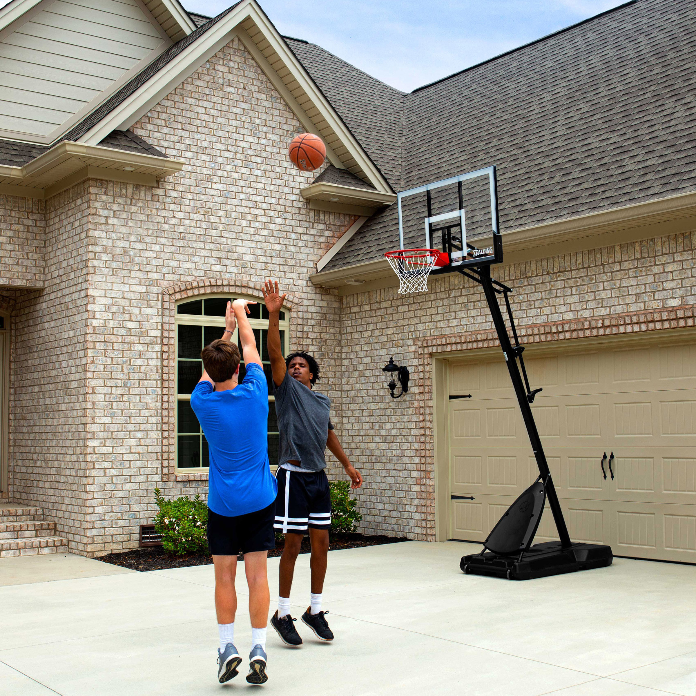 models playing with the hoop in a driveway