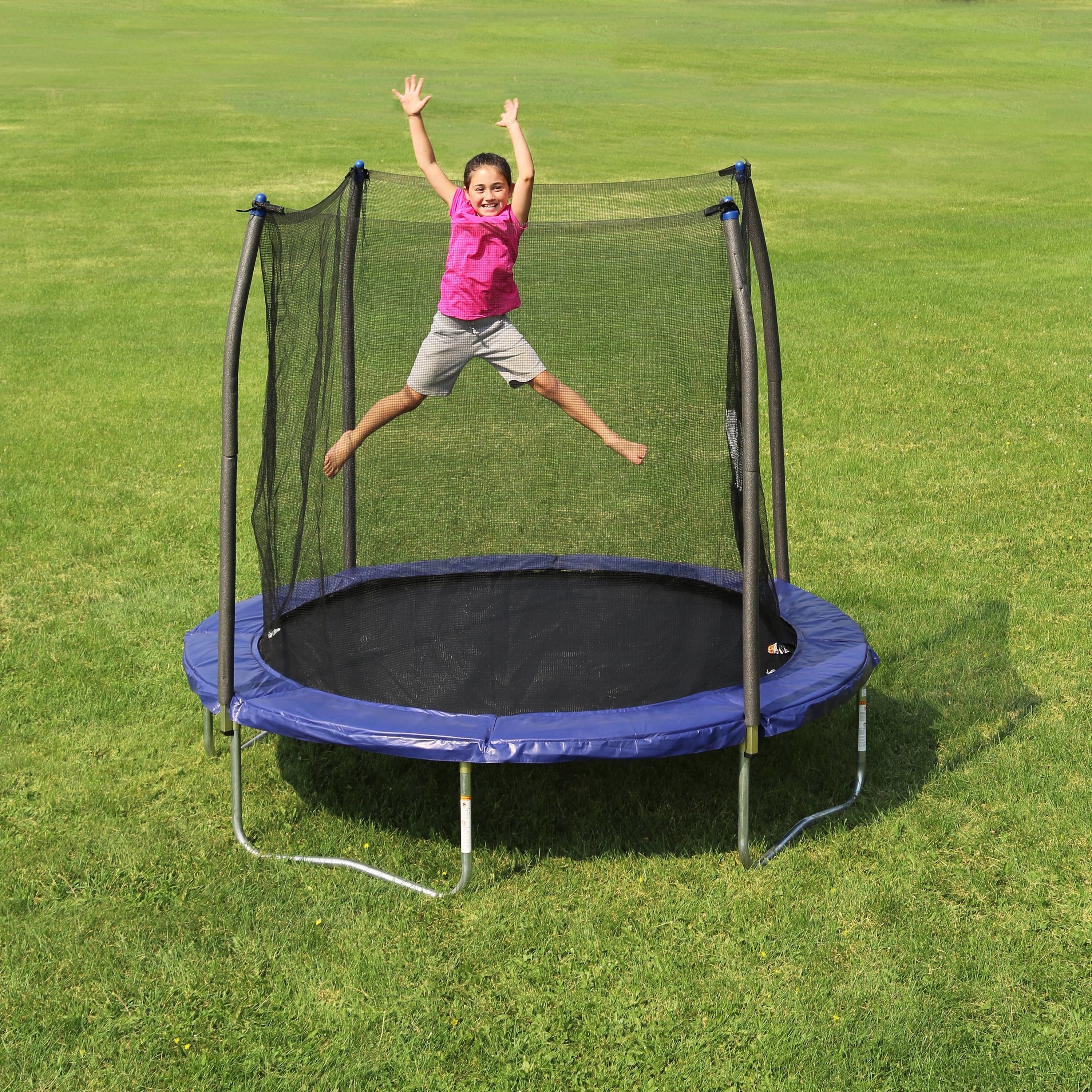kid jumping on the trampoline with safety net