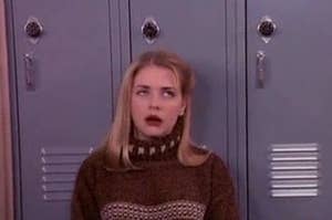 This is an image of Sabrina from Sabrina the Teenage Witch standing in front of lockers while rolling her eyes.