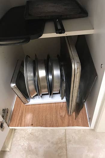 Reviewer's organized cabinet after using pots and pans holder