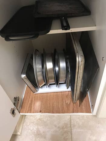 Reviewer's organized cabinet after using pots and pans holder