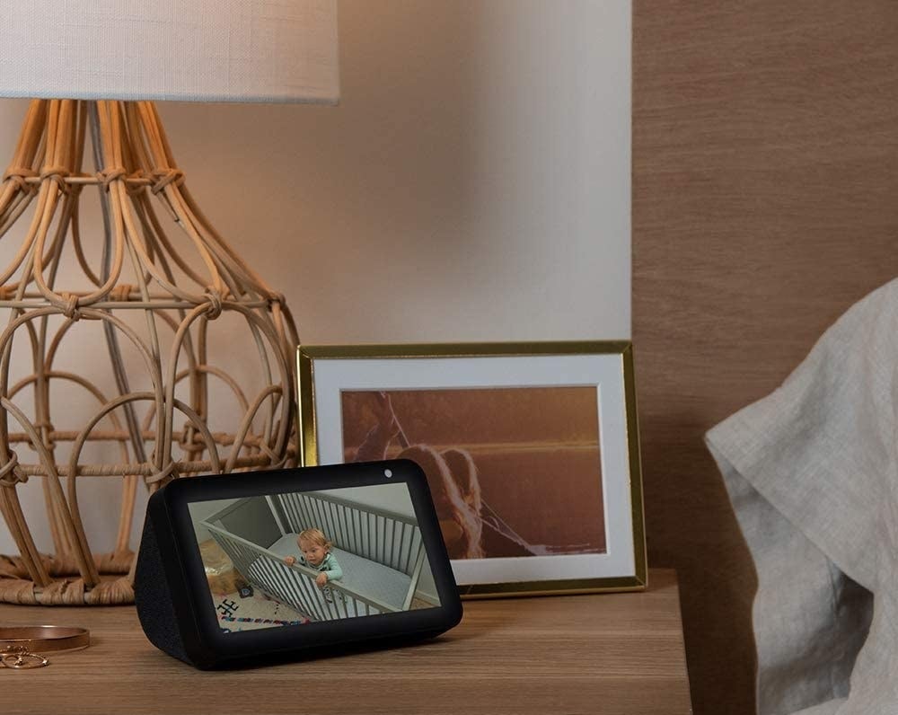 The Echo Show 5 on a nightstand with the image of a baby moniter