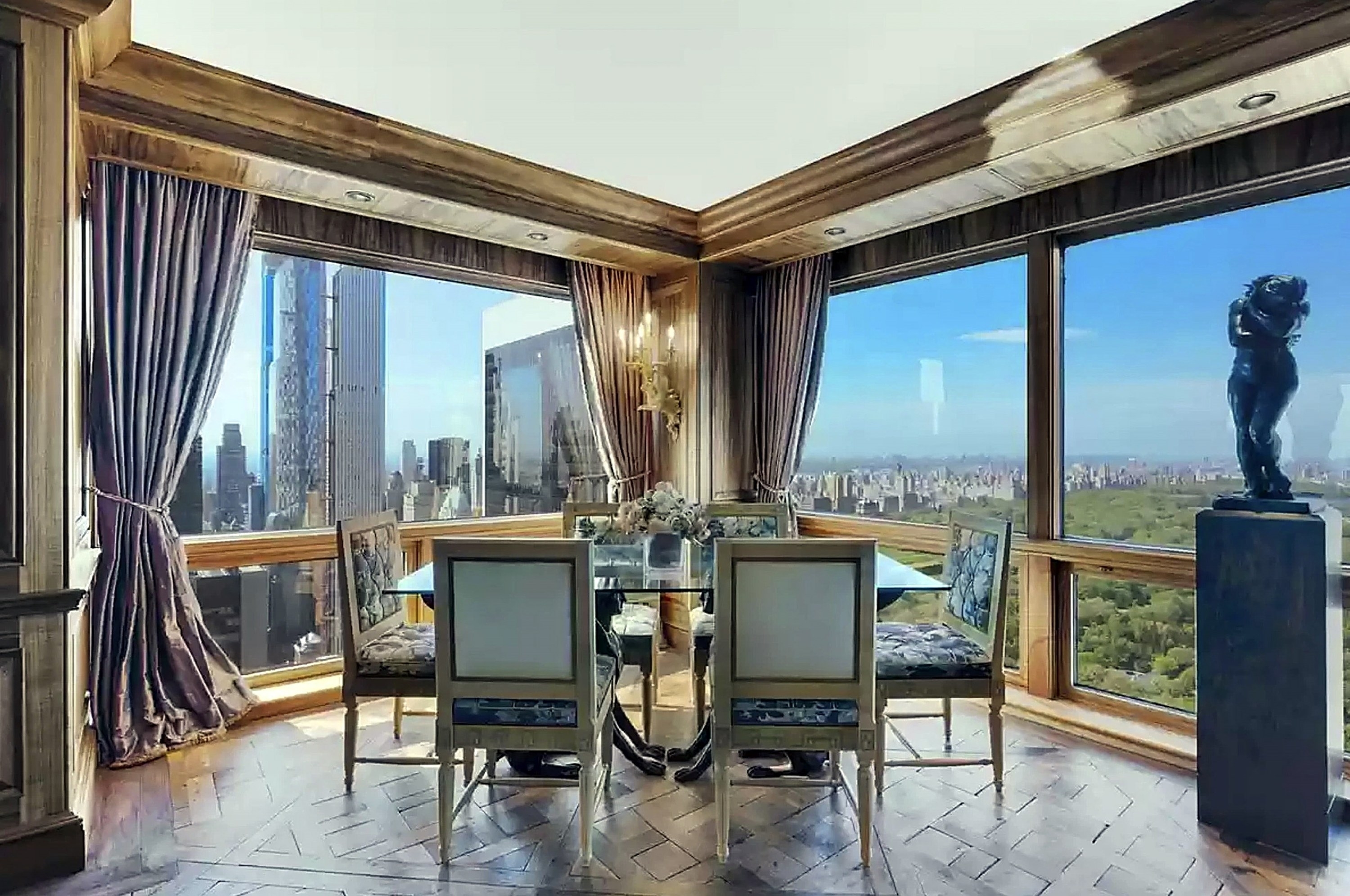 Glass-topped dining room table with uninterrupted views of skyscrapers and Central Park