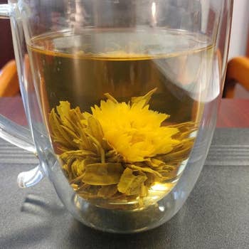 a reviewer photo of a clear mug with a blooming flower inside 