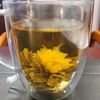 a reviewer photo of a clear mug with a blooming flower inside 