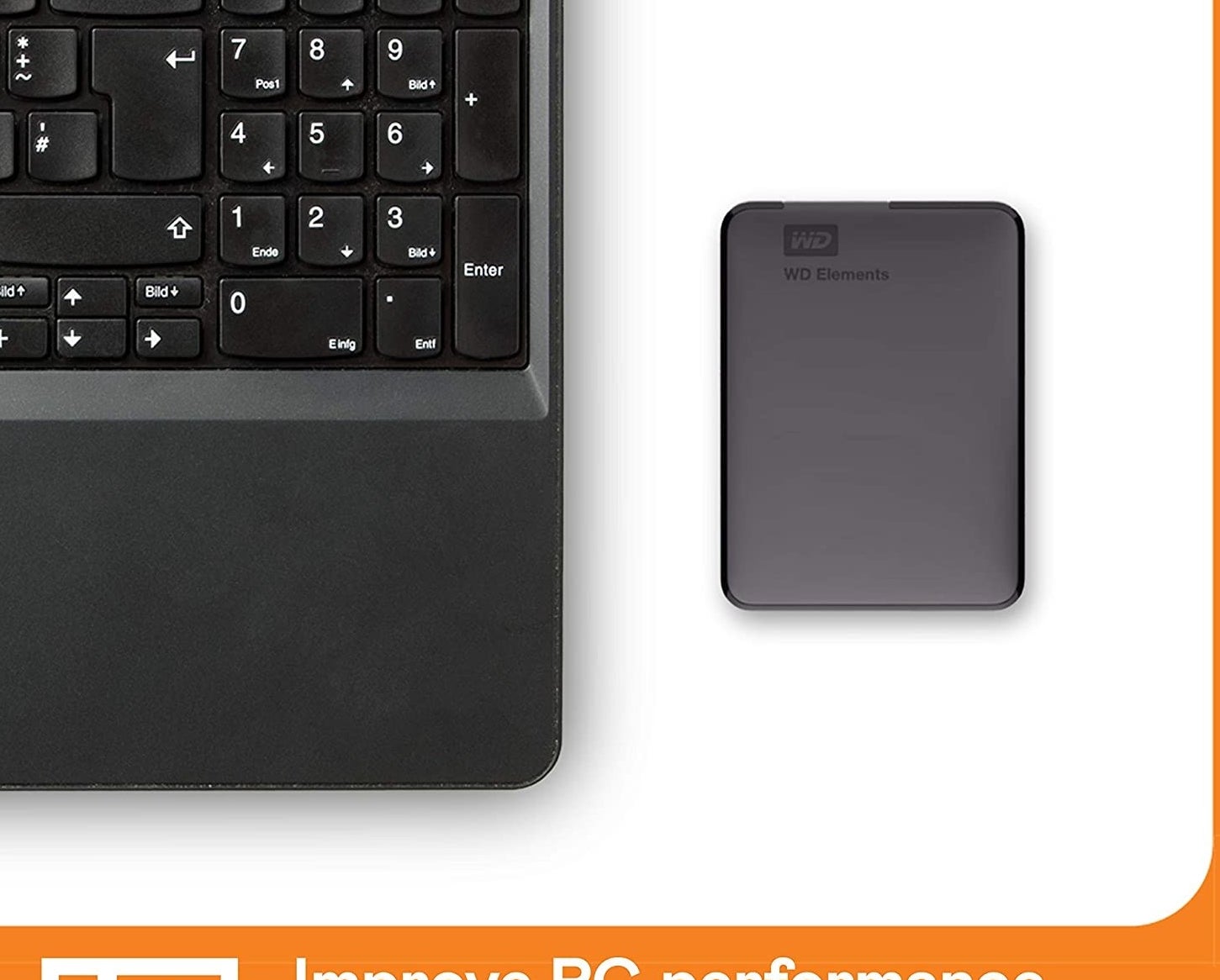 A black portable hard drive next to a laptop.