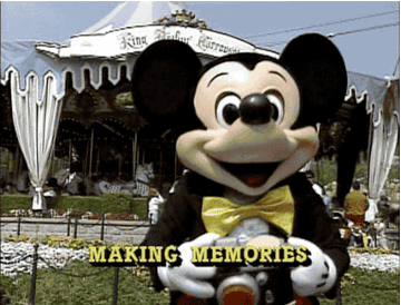 Micky Mouse taking a picture with the caption &quot;making memories&quot;