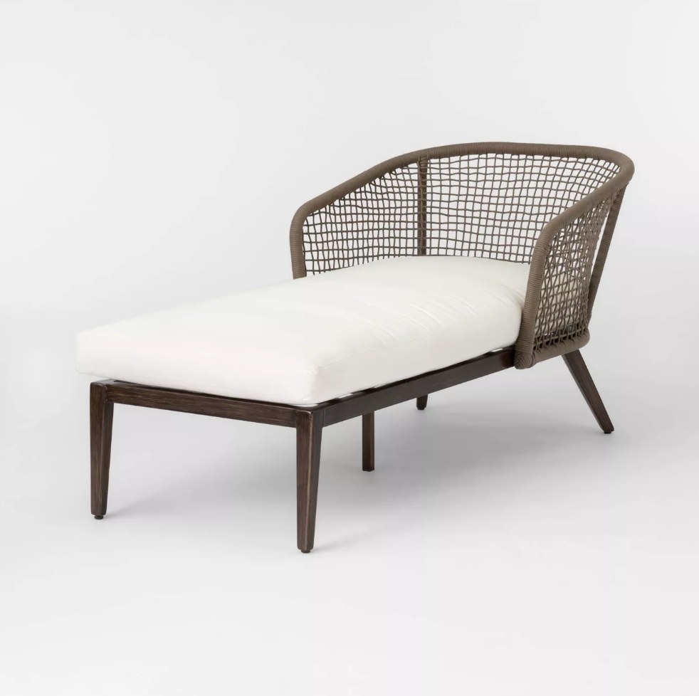 Chaise lounge chair with white cushion and wicker backrest 