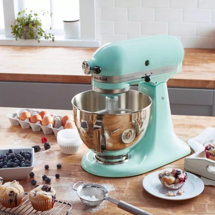 the mixer in ice blue on a counter with baking ingredients