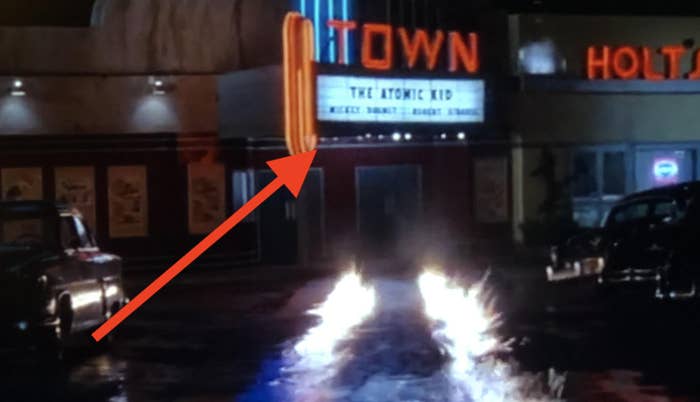 old time movie theatre with sign that says the atomic kid