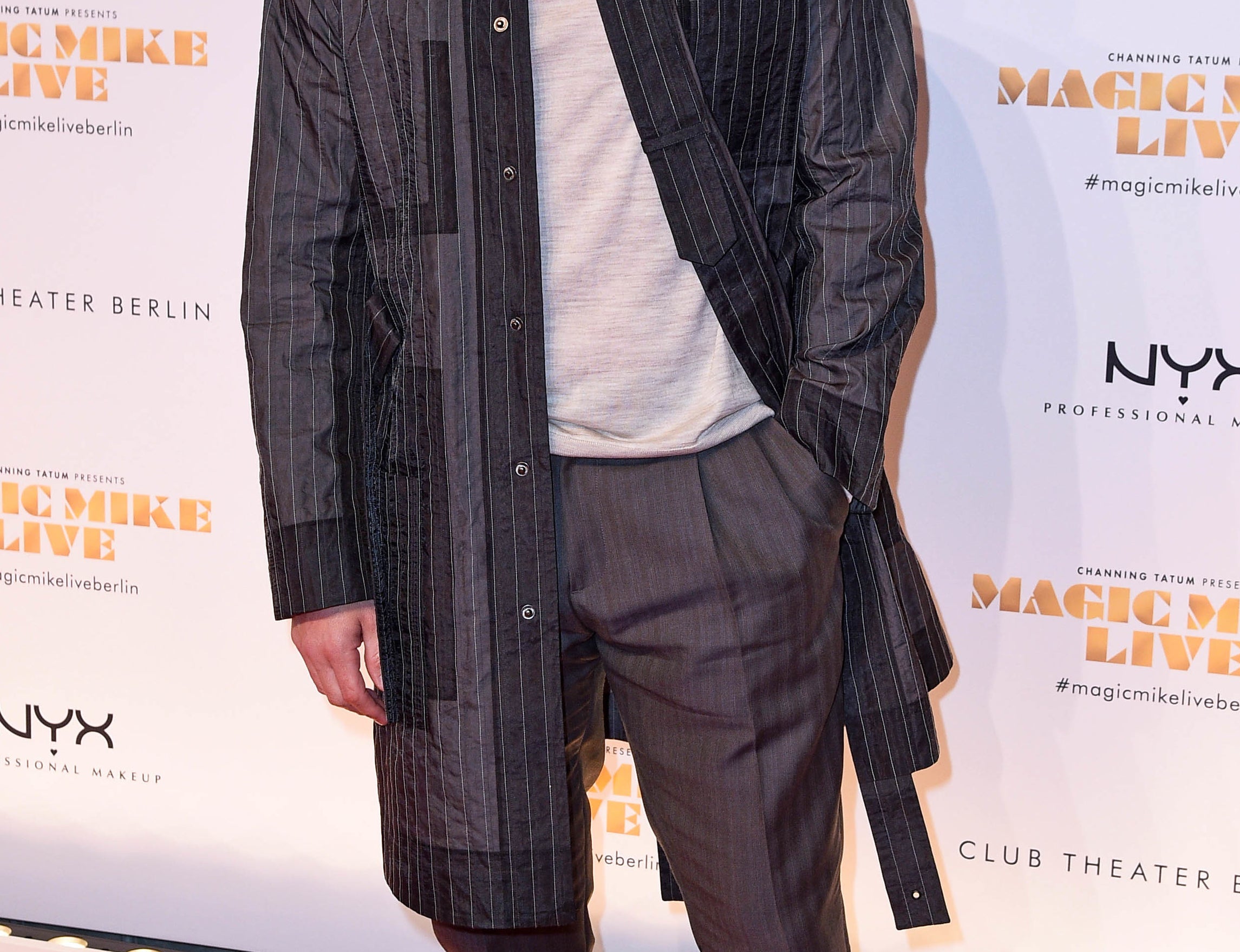 Channing wears a pin-striped jacket and gray turtleneck to an event