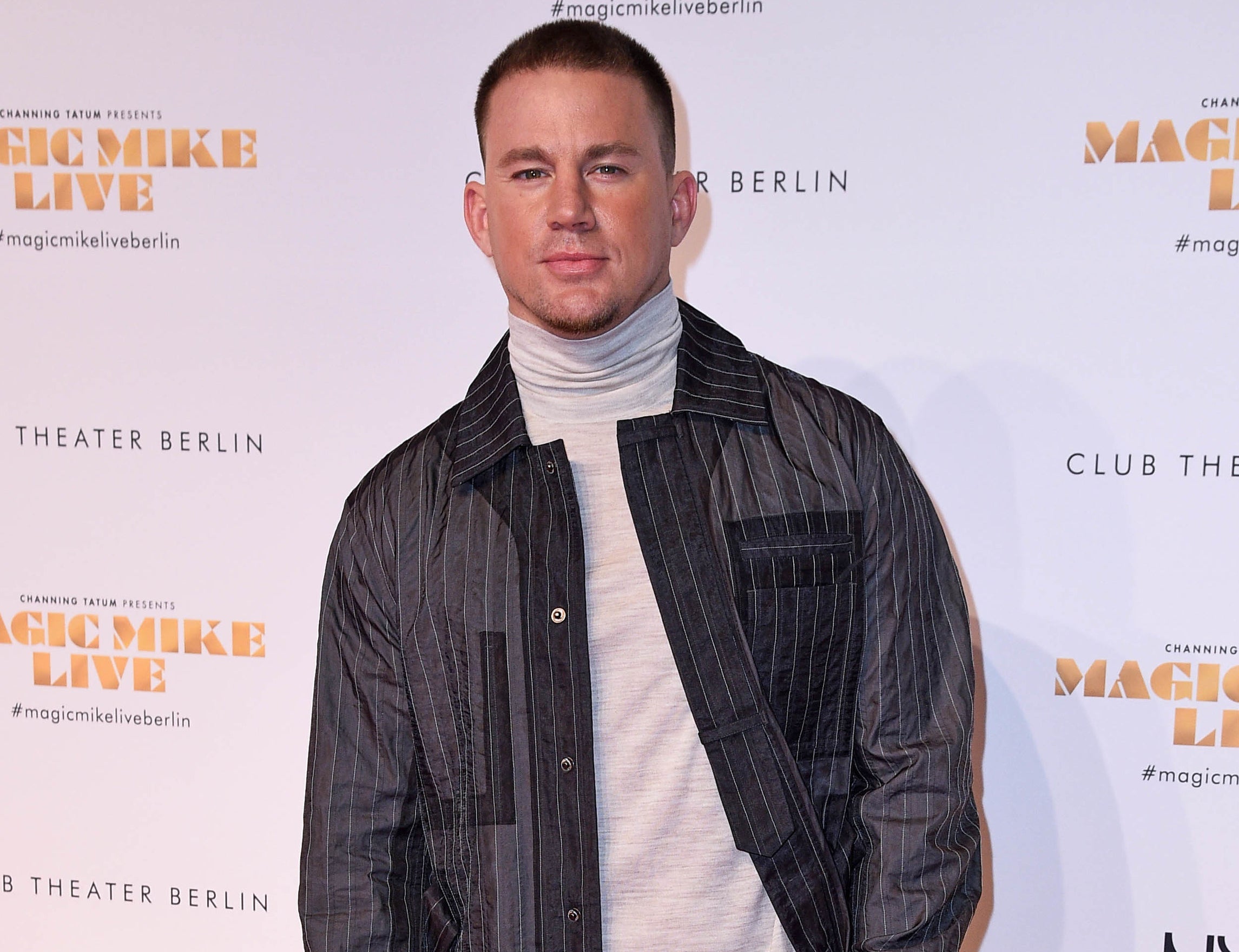 Channing wears a pin-striped jacket and gray turtleneck to an event