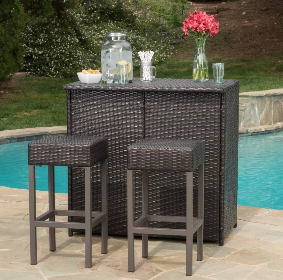 Brown wicker bar island with two matching stools