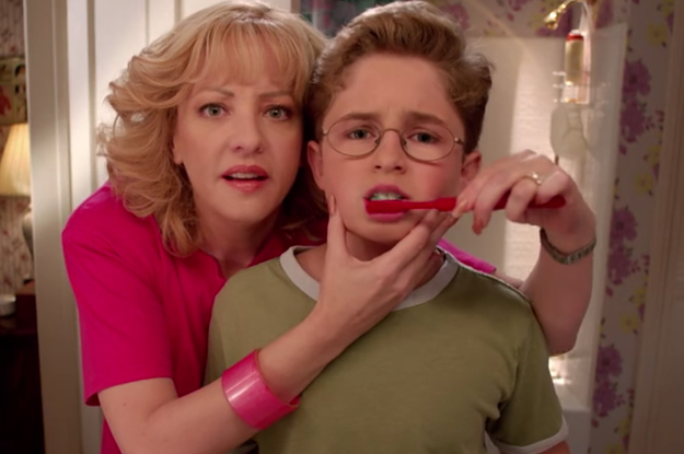 Beverly Goldberg holds her youngest son, Adam's, face in her hand as she brushes his teeth for him.