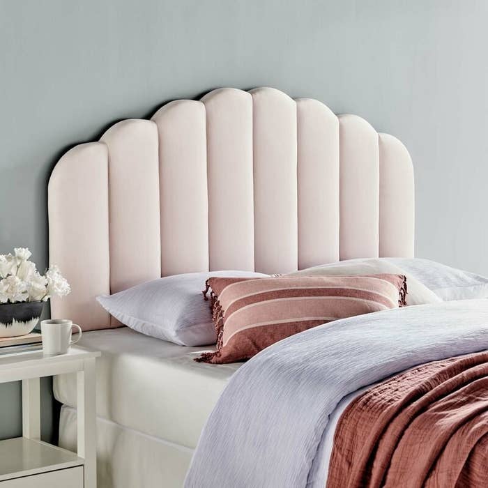 The pale pink panel headboard
