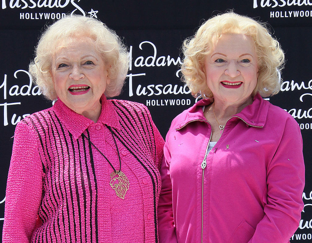 Betty White standing with her wax figure in Hollywood