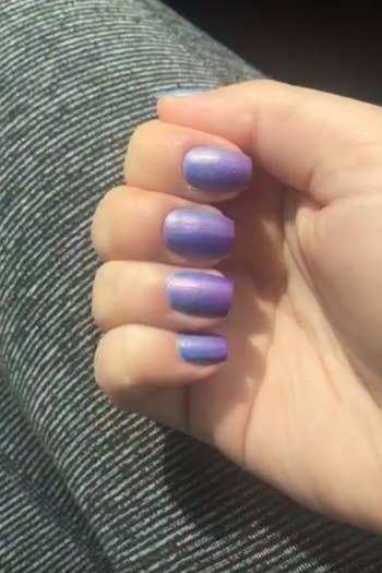 a reviewer photo of the same hand with the nails now looking purple 