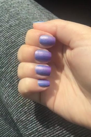a reviewer photo of the same hand with the nails now looking purple 