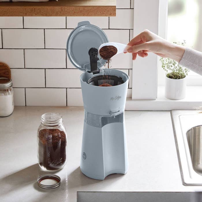 the small grey coffee maker on a counter