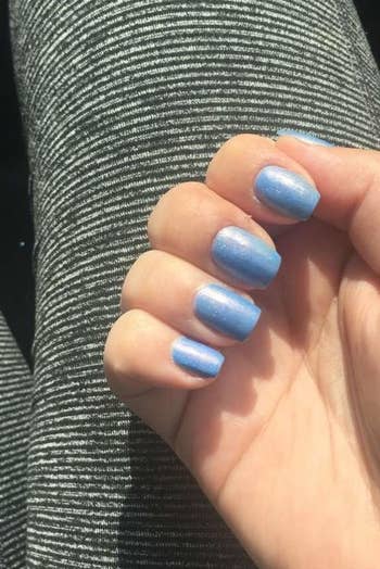 a reviewer photo of a hand with nails painted light blue 