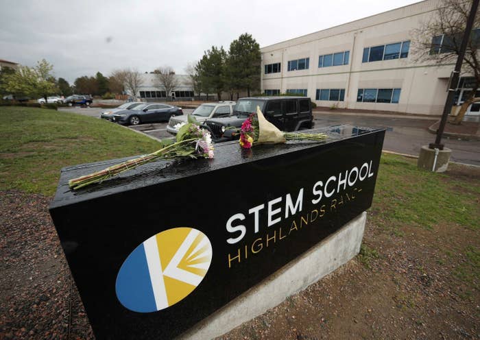 bouquet of flowers rests on sign at stem school highlands ranch in colorado