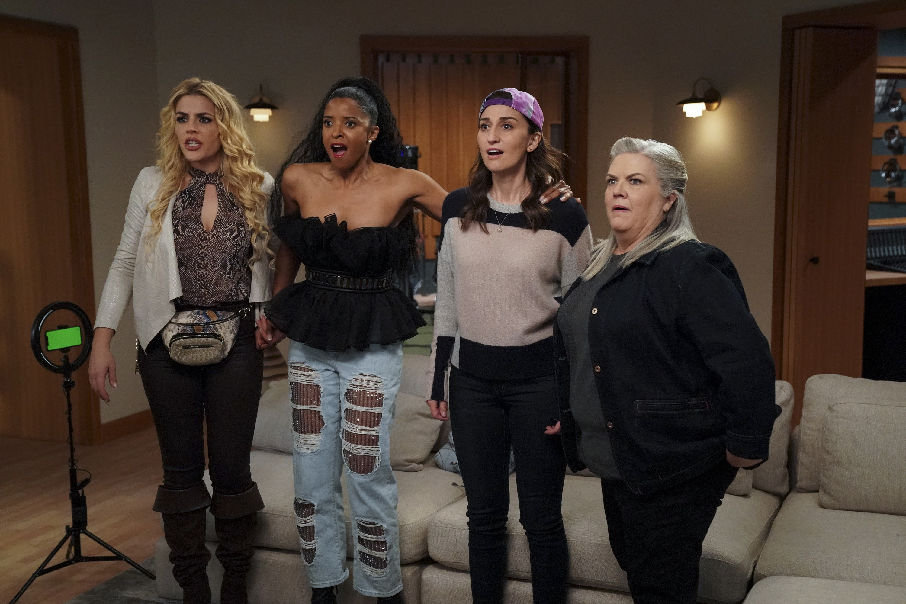 Busy Philipps, Renée Elise Goldsberry, Sara Bareilles, and Paula Pell look surprised in a still image from the third episode of &quot;Girls5eva&quot;