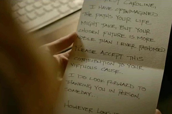 Caroline holding a note that reads, &quot;I have often imagined the paths your life might take, but your chosen future is more noble than I ever fathomed&quot;