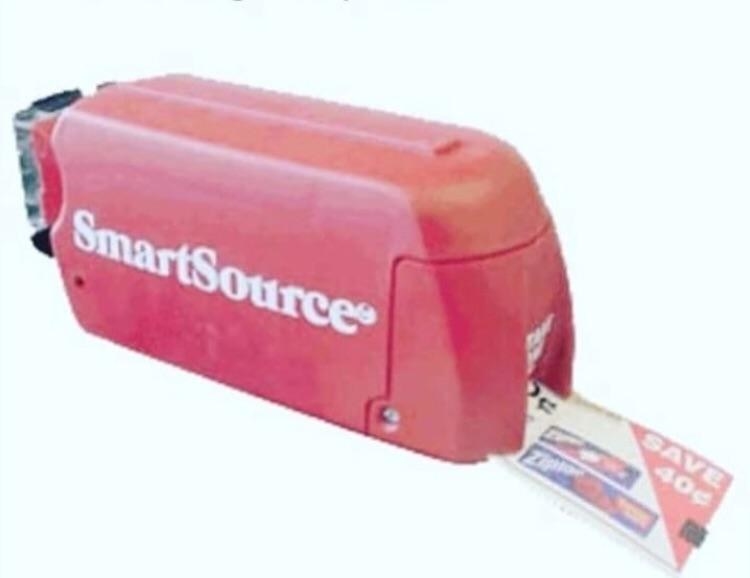 A SmartSource coupon machine spitting out a coupon