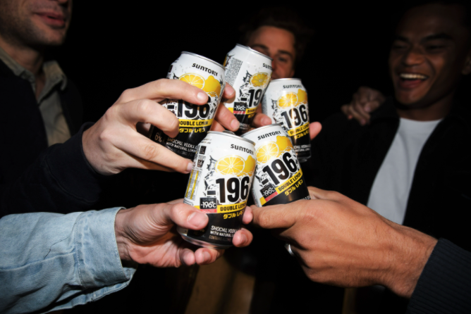 A close up of hands holding cans of Minus 196 Double Lemon