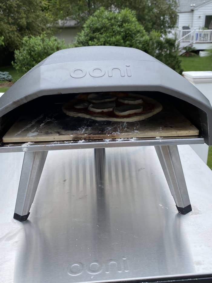 the pizza oven with pizza cooking inside of it 