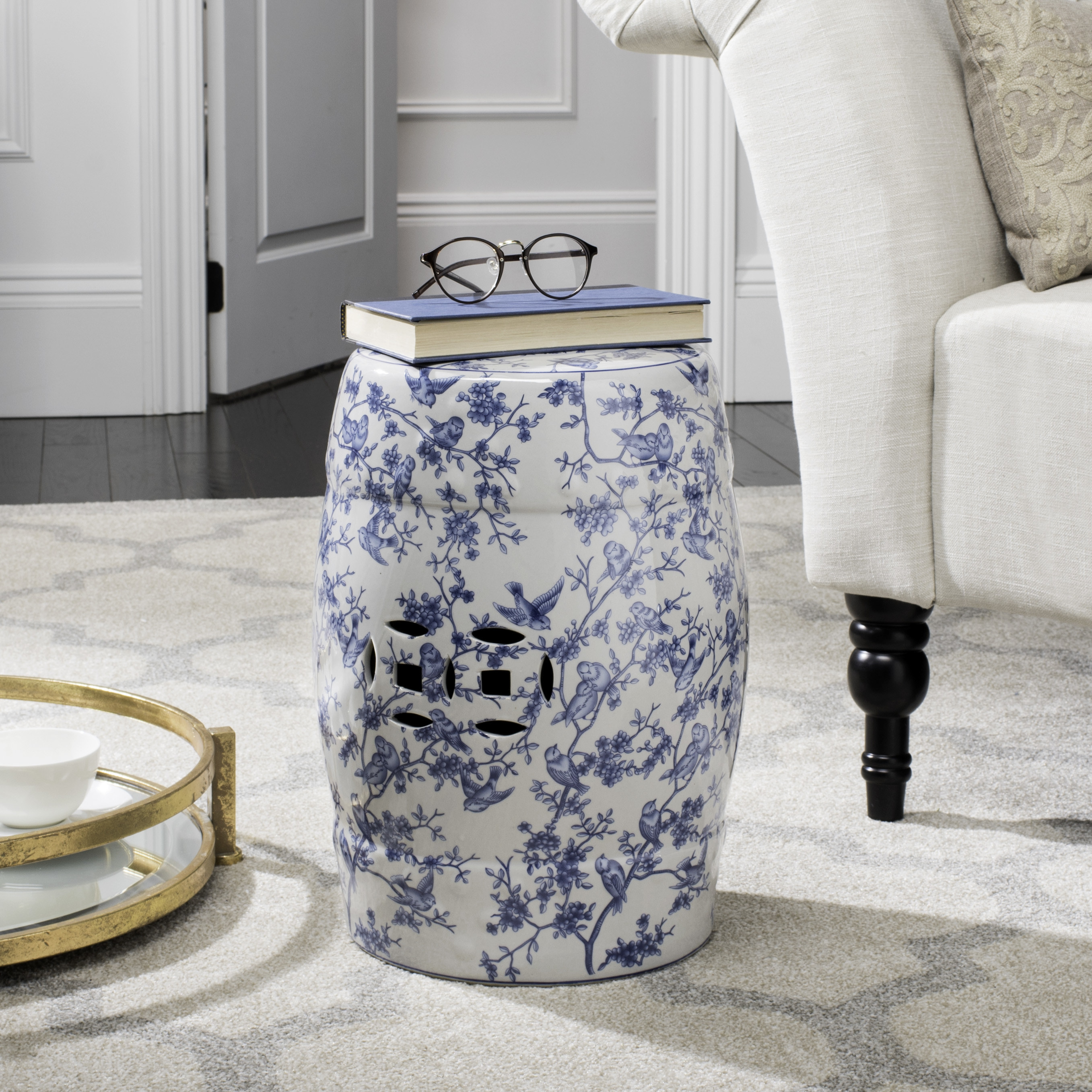 blue and white chinoiserie stool in a living room