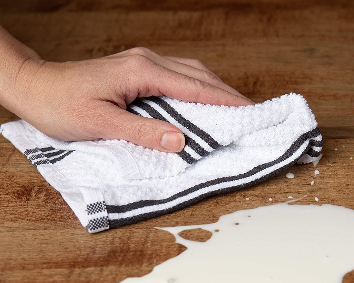 Person mopping up a spill with the dish towel