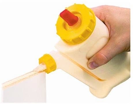 a person using wood glue dispenser on a wall