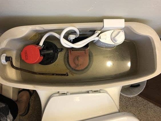 An automatic toilet bowl cleaning system with bleach cartridge inside a reviewer&#x27;s toilet