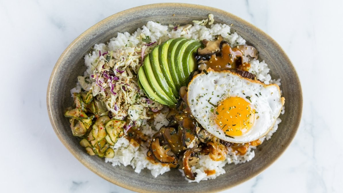 Rice bowl with veggies, avocado, and fried egg
