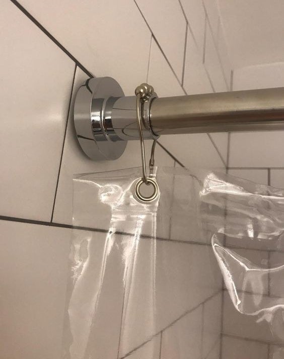 A stainless steel shower rod inside a reviewer’s bathroom
