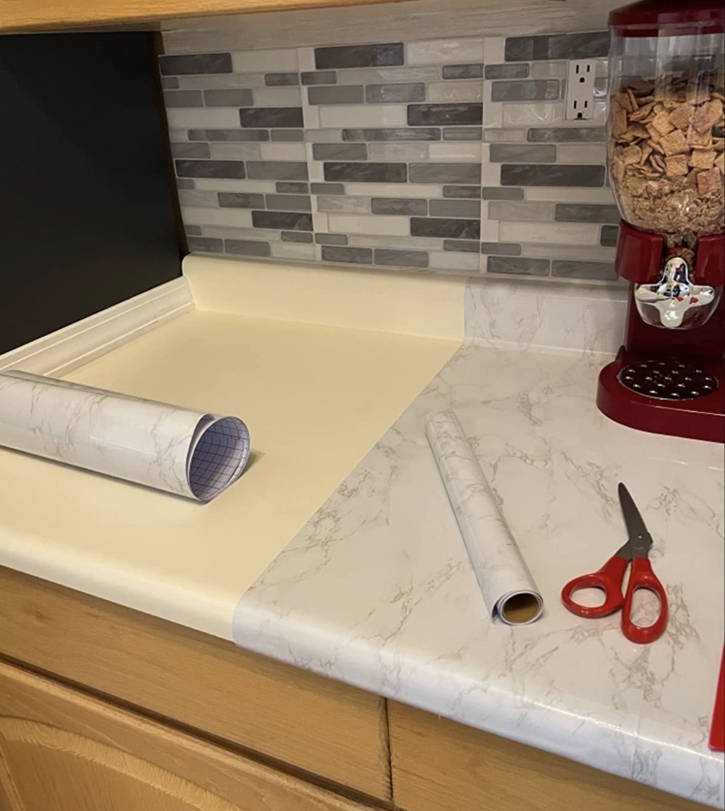 reviewer photo showing the contact paper applied to half of their countertop