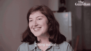 Woman smiling and saying &quot;Dating sucks!&quot;