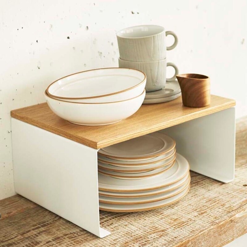 A wooden-topped kitchen rack laden with dishes