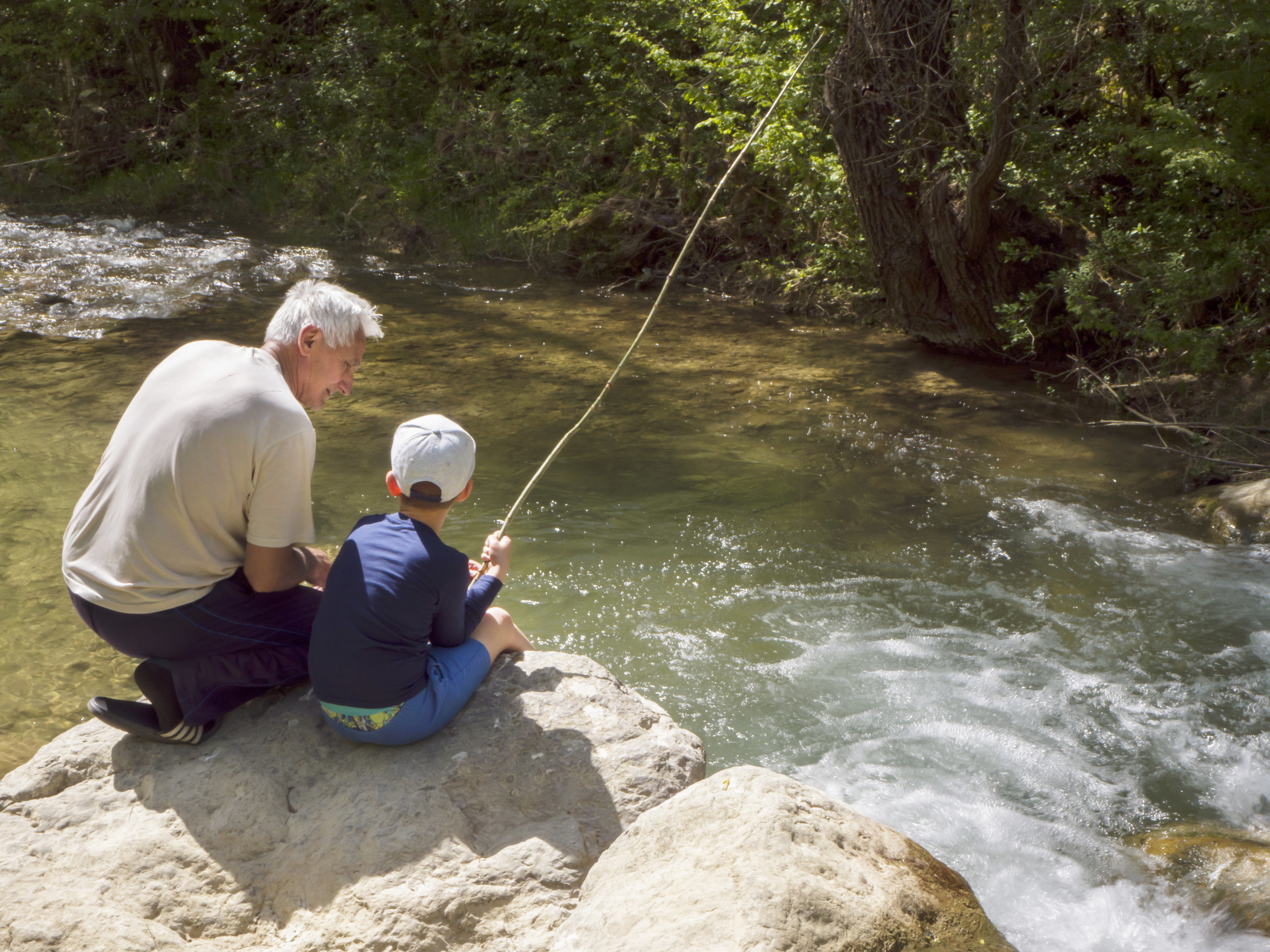 An old man and young boy fishing