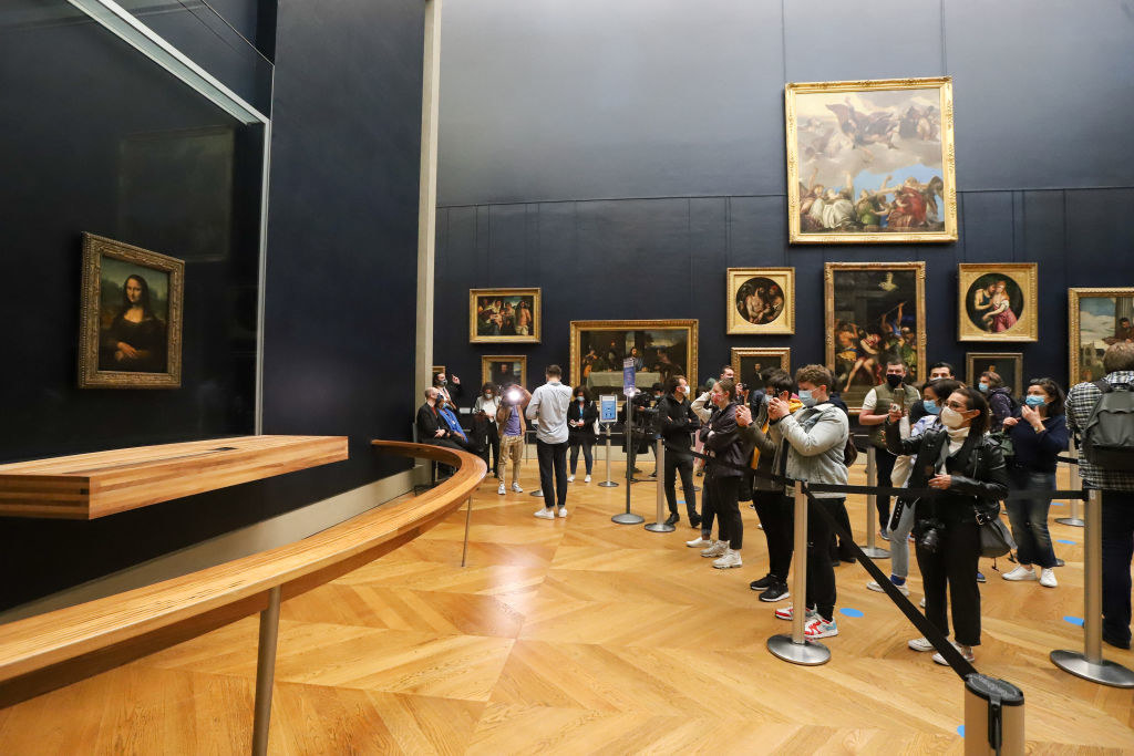 People gathering at the Louvre Museum in front of the Mona Lisa