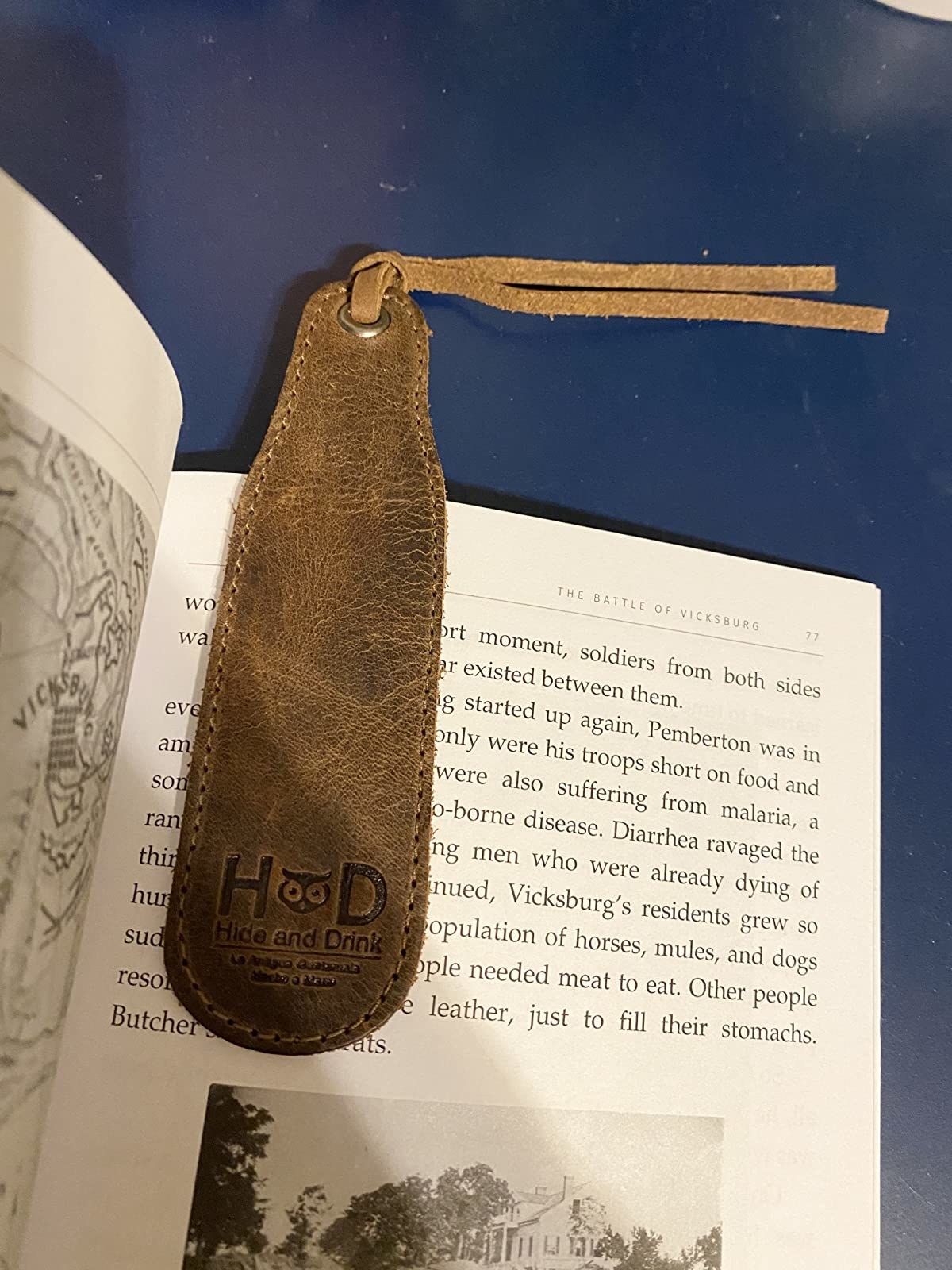 reviewer photo of the bookmark in brown marking a page