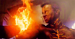 A hand is gripped on Parrish&#x27;s arm, as Parrish&#x27;s whole body lights up in flames.