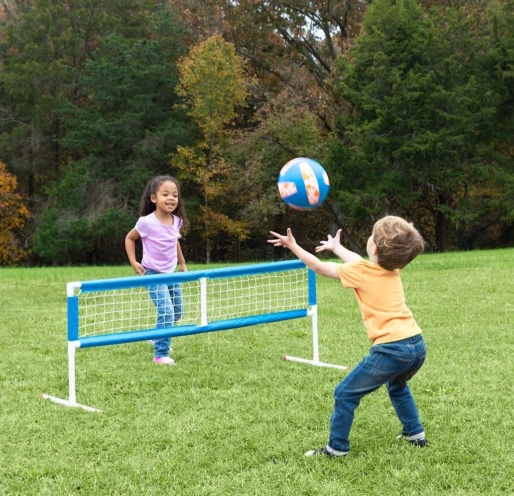 Two kids playing volleyball