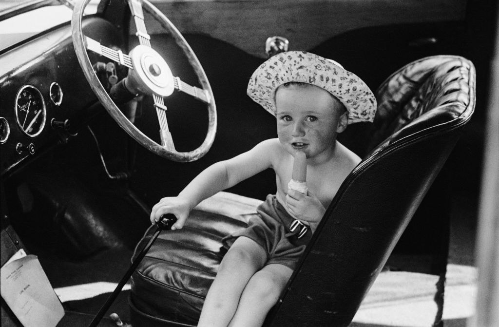 kid in front seat of a car