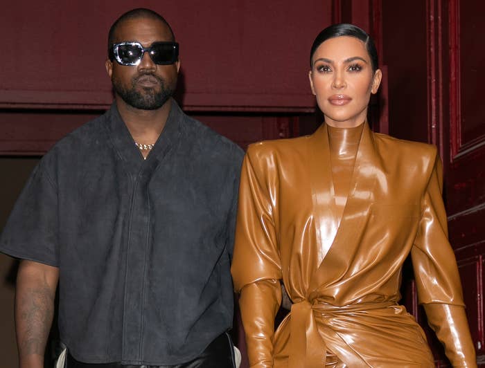Kim and Kanye look serious while exiting a building
