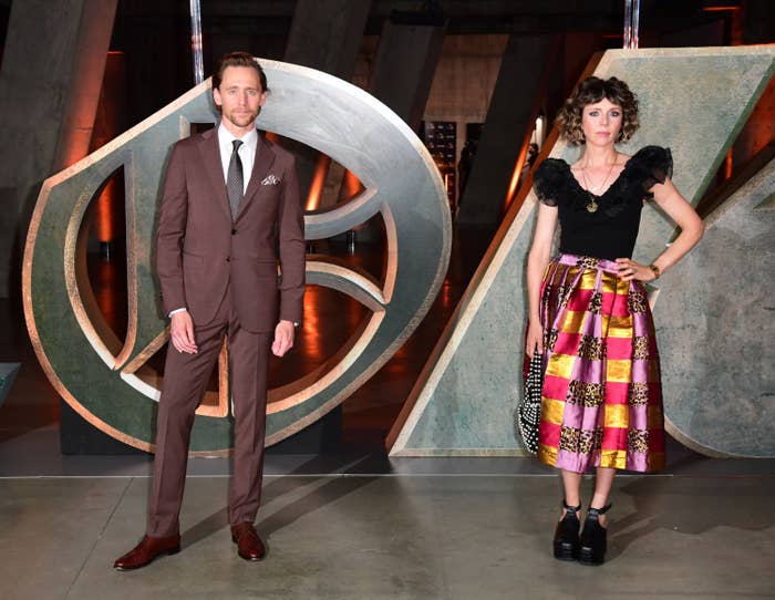 Tom Hiddleston and Sophia De Martino stand side-by-side at a "Loki" event
