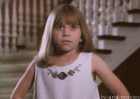 A gif of a young Mary Kate Olsen pretending to faint 