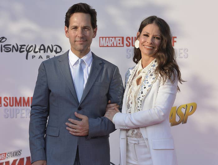 Evangeline holds onto Paul Rudd while posing at an event